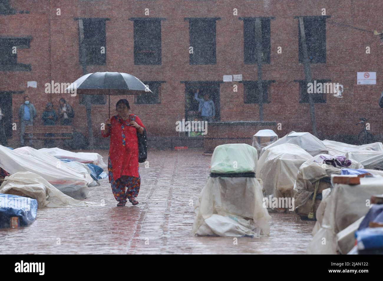 On May31, 2022 in Kathmandu, Nepal. Women carrying umbrella walk