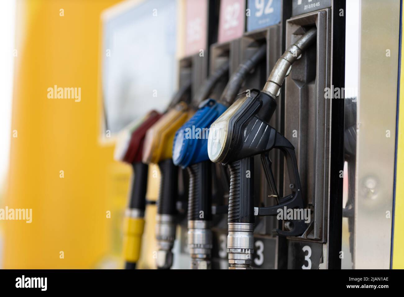 Close up filling gun in his hand at gas station. Sanctions economy crisis Stock Photo