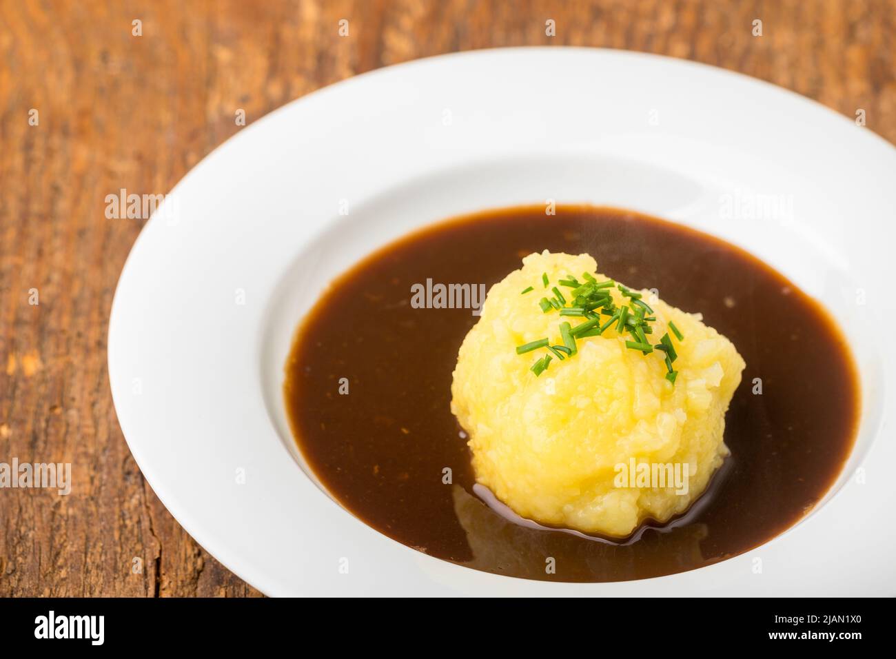 bavarian dumpling in a plate with sauce Stock Photo