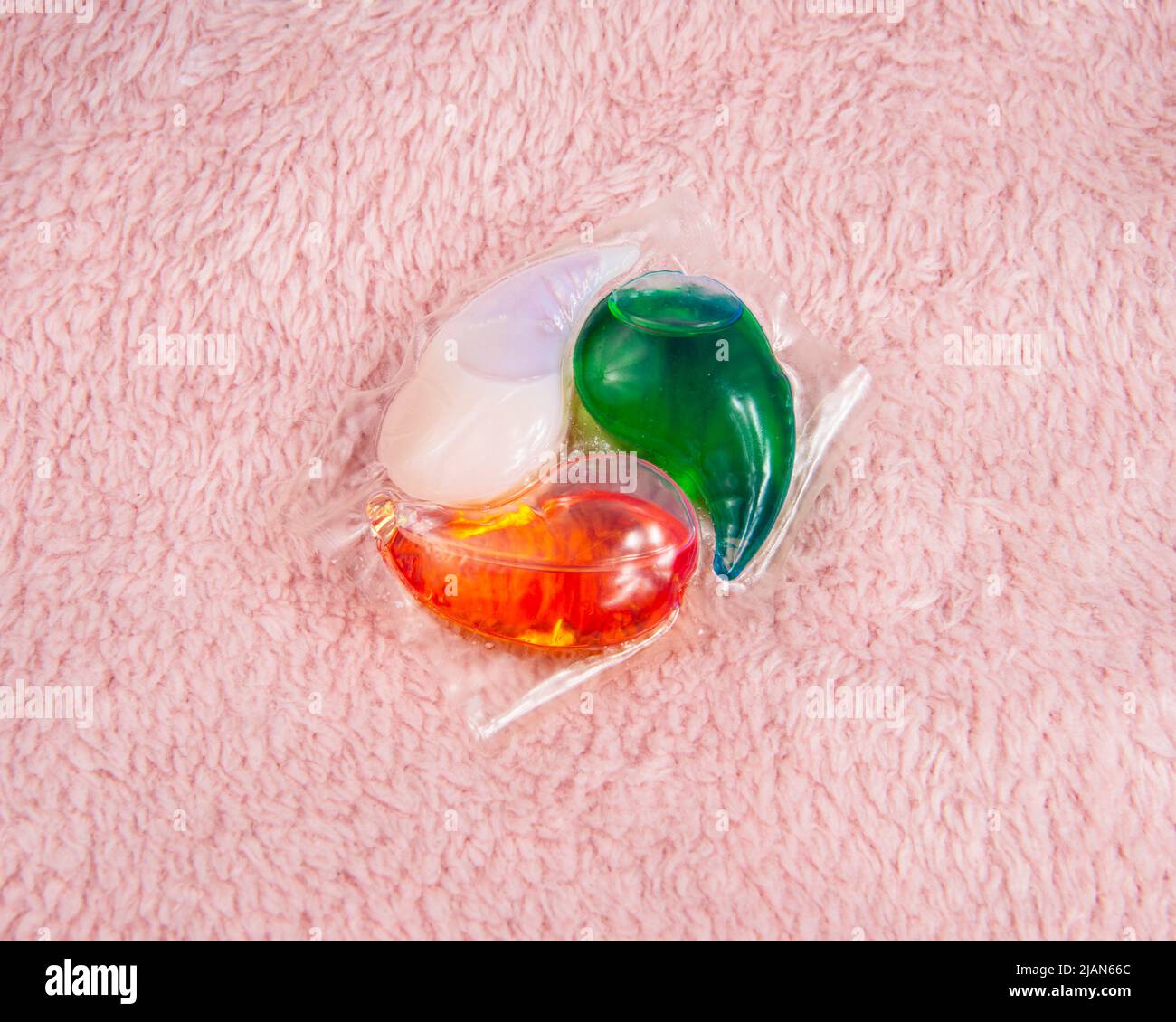Multicolor gel capsule for washing powder on fabric textile Stock Photo
