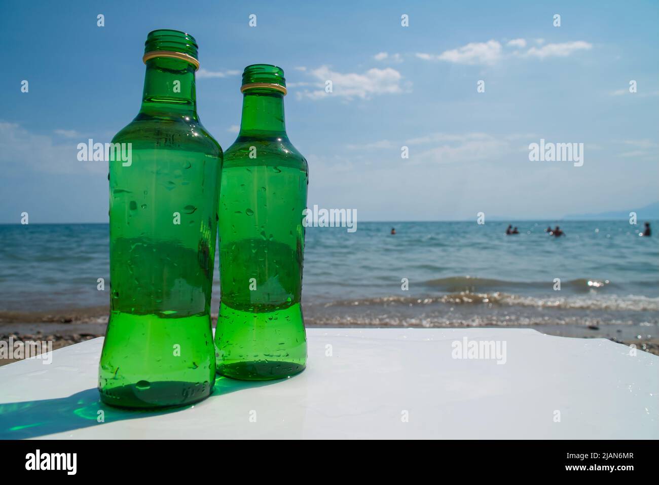 Water bottle on a white table, on the beach. Hydration and drinking regime Stock Photo