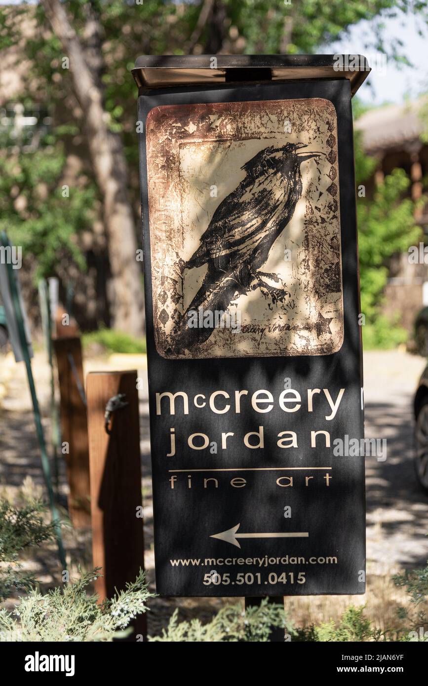 A sign with a raven for McCreery Jordan Fine Art in Santa Fe, New Mexico, with a bird in earth tones. Stock Photo