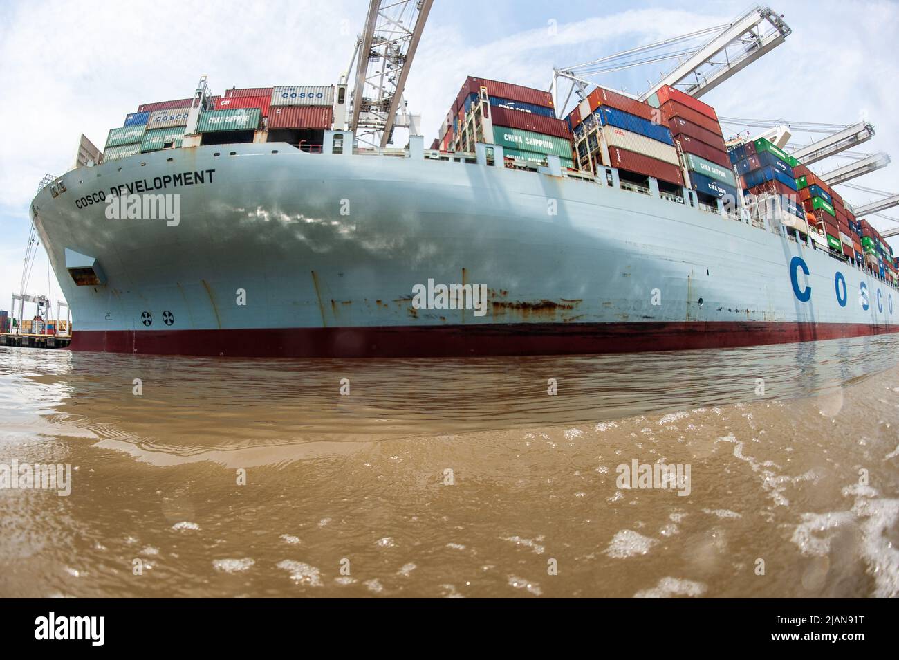 COSCO Development container ship, the largest vessel to call on the East Coast, entered the Savannah River Harbor, heading to Georgia Ports Authority Stock Photo
