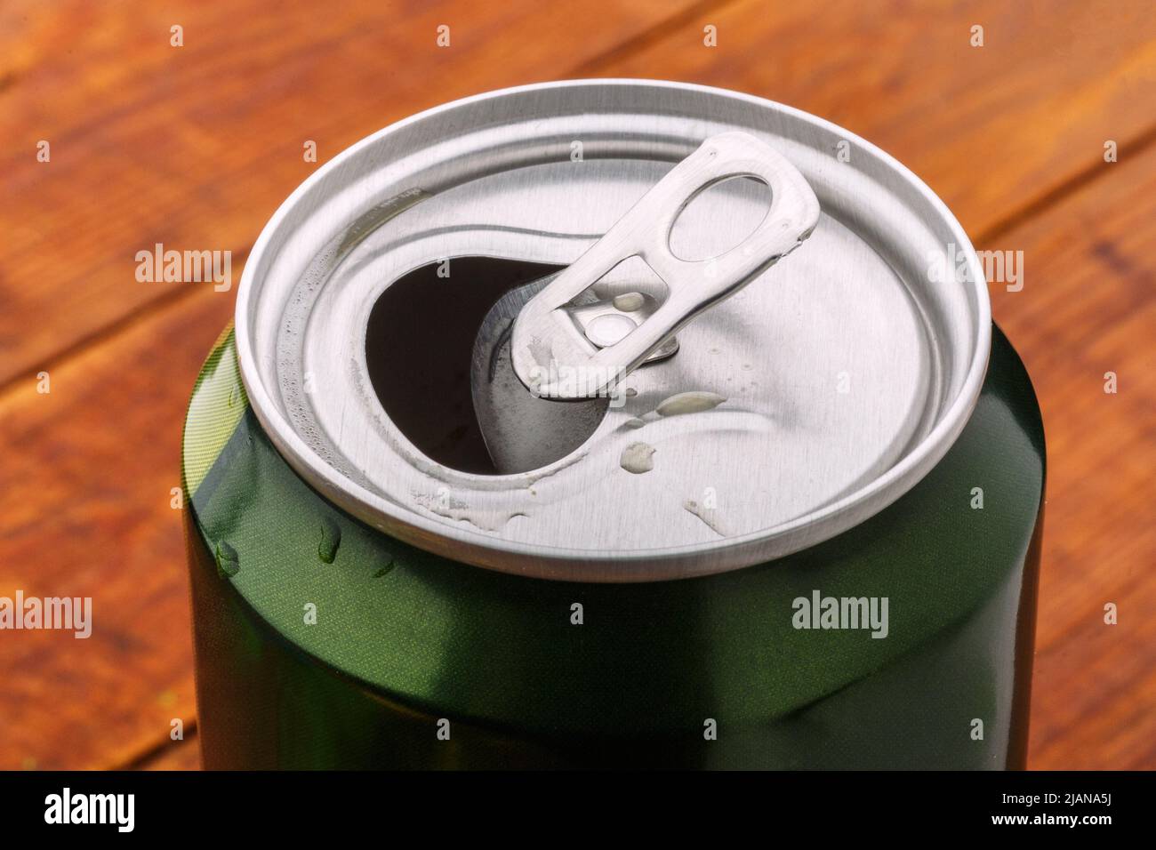 Can with drink view from the top. Green open soda aluminum can. Shiny metalic beer container close up Stock Photo
