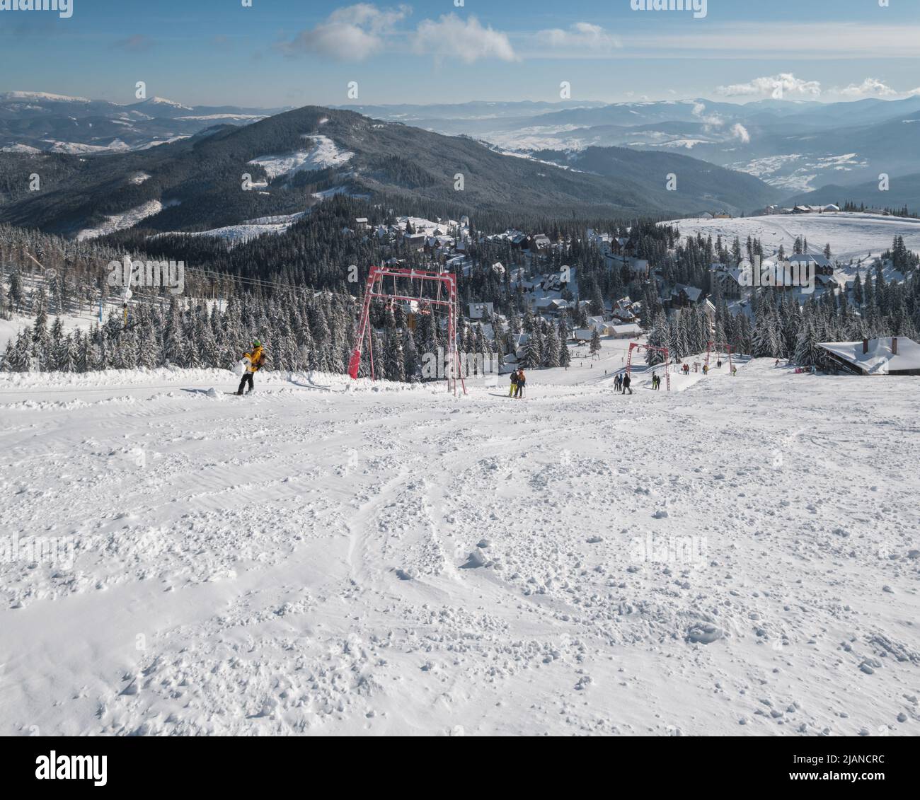 Winter snow covered mountain ski resort slope . Magnificent sunny day 