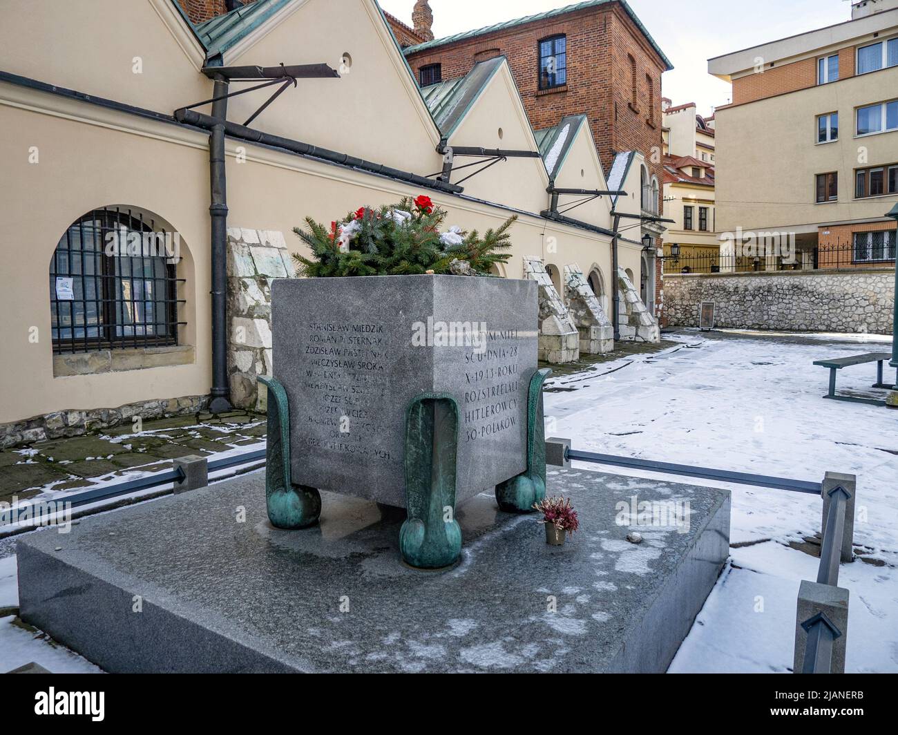 The monument to the memory of Krakow's Holocaust victims is located in a square in the middle of Szeroka Street. The memorial boulder with a plaque is Stock Photo