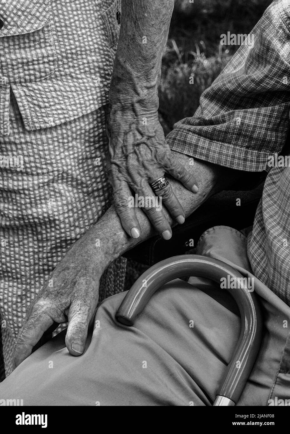 Older woman standing with hand on husband's arm Stock Photo