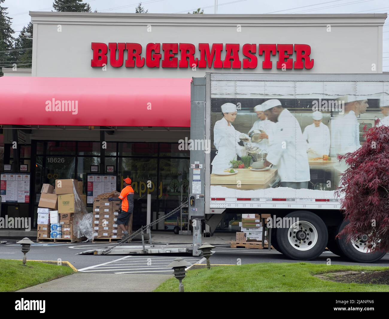 Mill Creek, WA USA - circa May 2022: Street view of the front of a Burgermaster fast food restaurant as they are receiving a food delivery Stock Photo