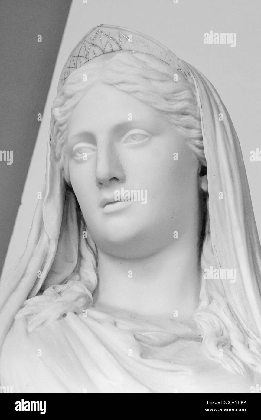 White marble head of young woman. Statue of a woman in the antique