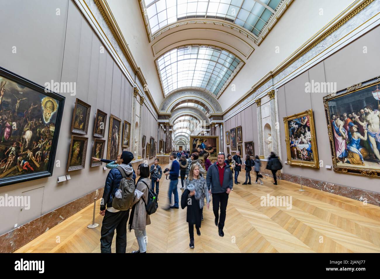 Paris, France - March 18, 2018: Inside of the Parisian Louvre Museum with crowds of people visiting it Stock Photo