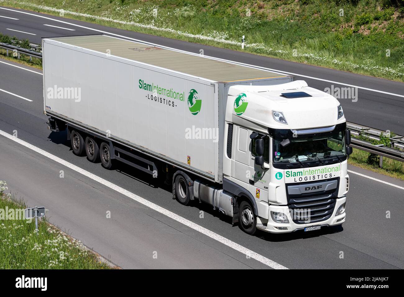 Slam International DAF XF truck with box trailer on motorway. Stock Photo