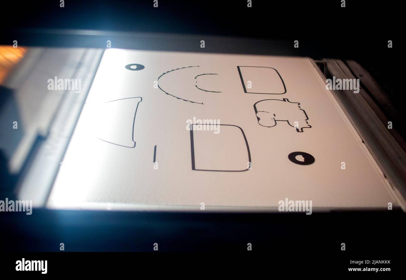 Powder 3D printer printing models from white powder polyamide closeup