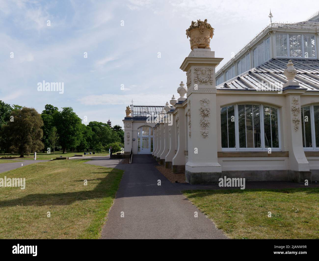 Richmond, Greater London, England, May 18 2022: Royal Botanic Gardens Kew. Side view of the Temperate House set within a lawn and trees. Stock Photo