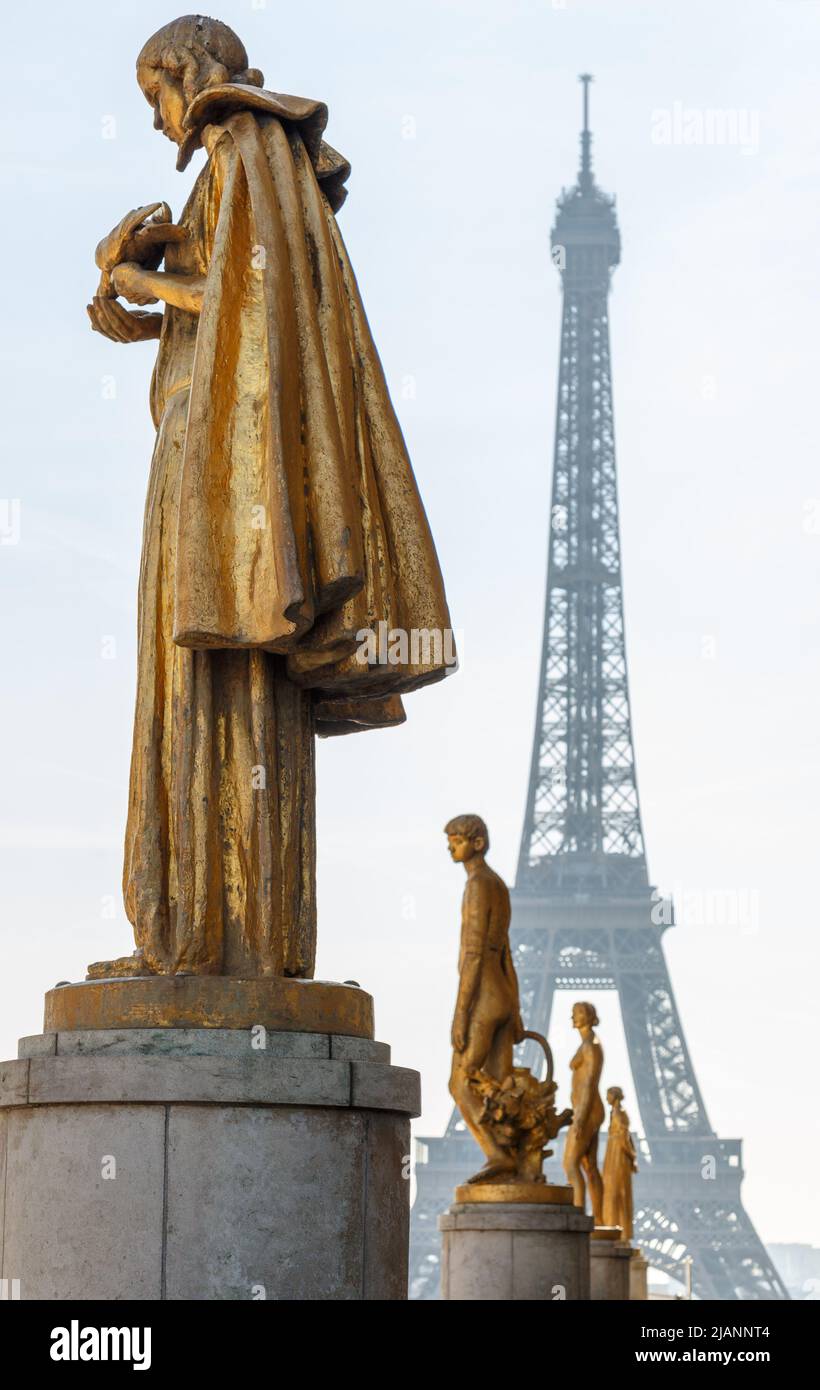 Paris, France, March 27 2017: Row of golden statues, Place du Trocadero in city Paris,on a summer morning, in front of the Eiffel tower Stock Photo