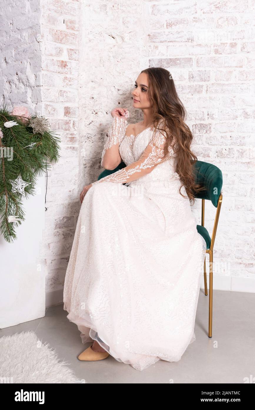 The bride in a white dress sits on a chair. High quality photo Stock ...