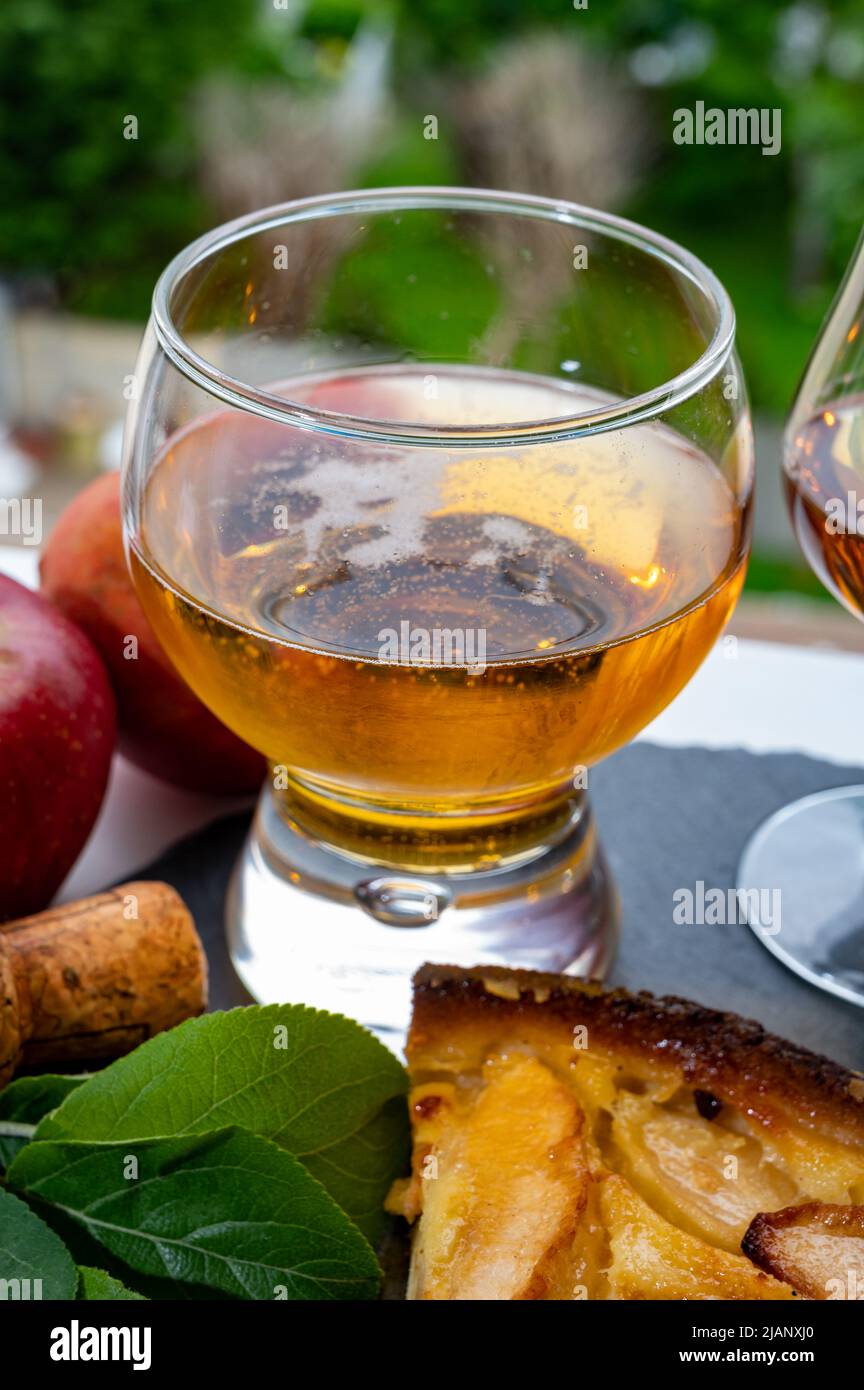 Apple products of Normandy region, homemade baked apple cake, glasses of calvados and cider