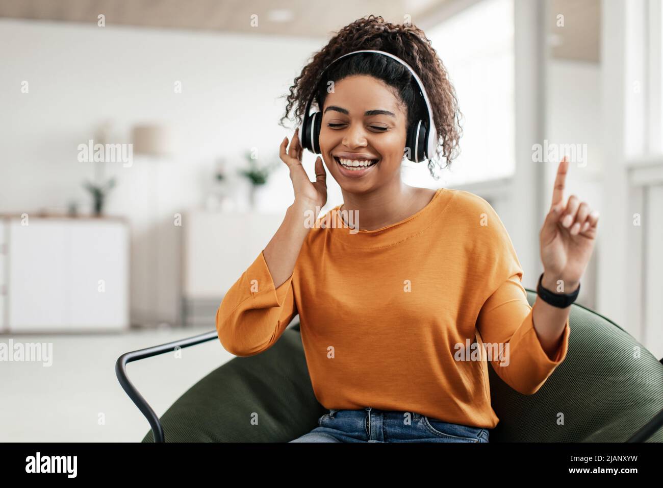 Excited young african woman dancing hi-res stock photography and images ...