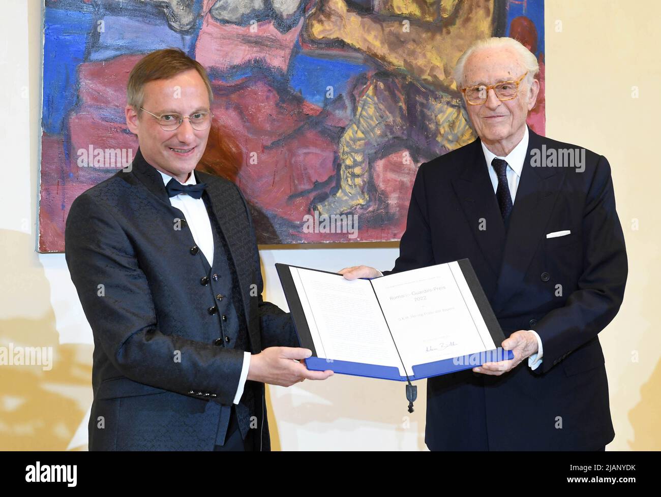 Munich, Germany. 31st May, 2022. Achim Budde (l), director of the 'Catholic Academy in Bavaria,' and the honored Duke Franz of Bavaria stand on stage at the award ceremony for the Romano Guardini Prize. The 88-year-old head of the House of Wittelsbach, Duke Franz of Bavaria, receives the 10,000-euro award for his lifelong commitment to areas of culture and science at the Catholic Academy of Bavaria. Credit: Felix Hörhager/dpa/Alamy Live News Stock Photo
