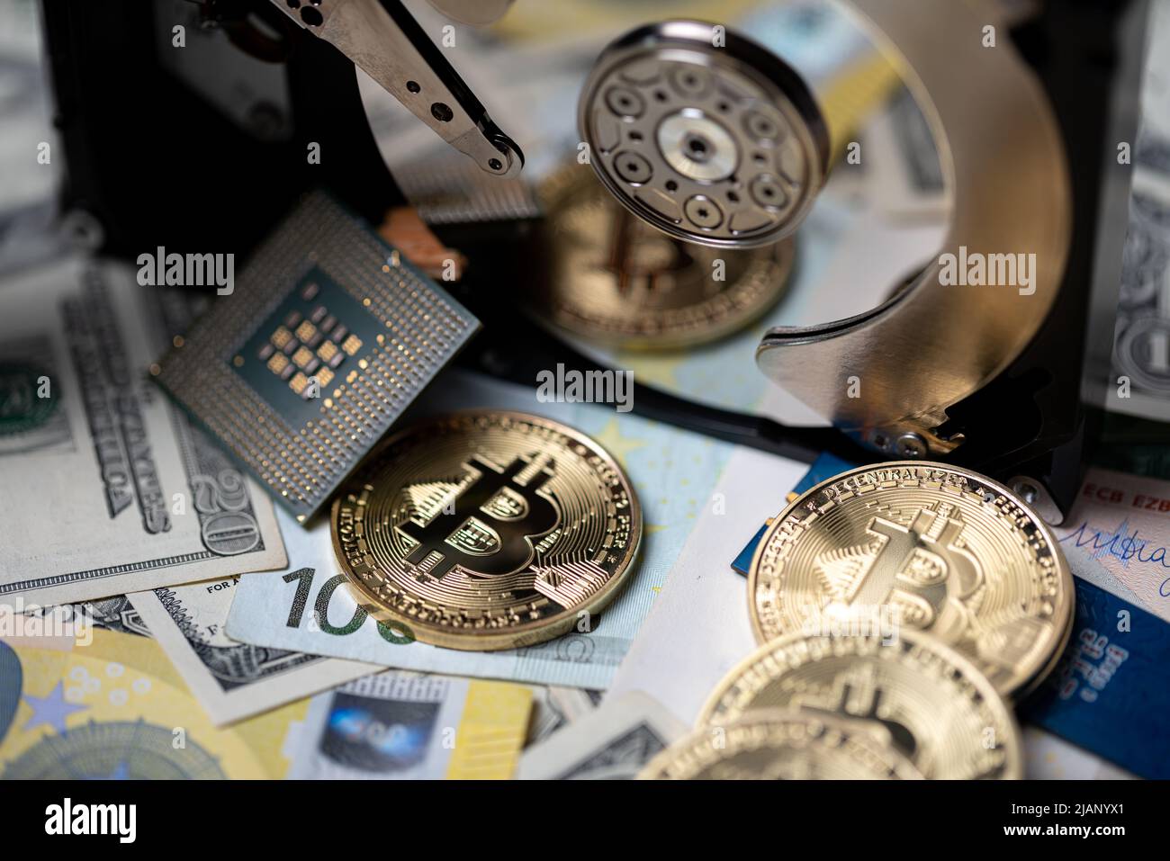 Bitcoin on dollar and euro bills reflecting on hard drive disk. Concept of storing crypto blockchain Stock Photo