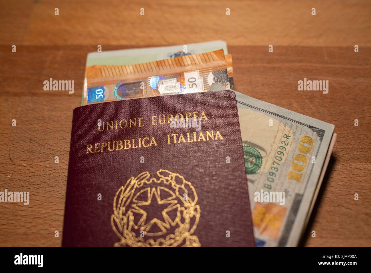 Closeup of Italian passport with euro and dollar banknotes inside