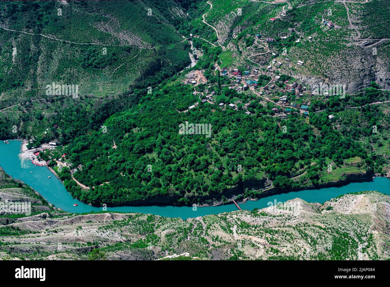 top view of the mountain river Sulak in Dagestan with the village of Old Zubutli with a boat pier Stock Photo