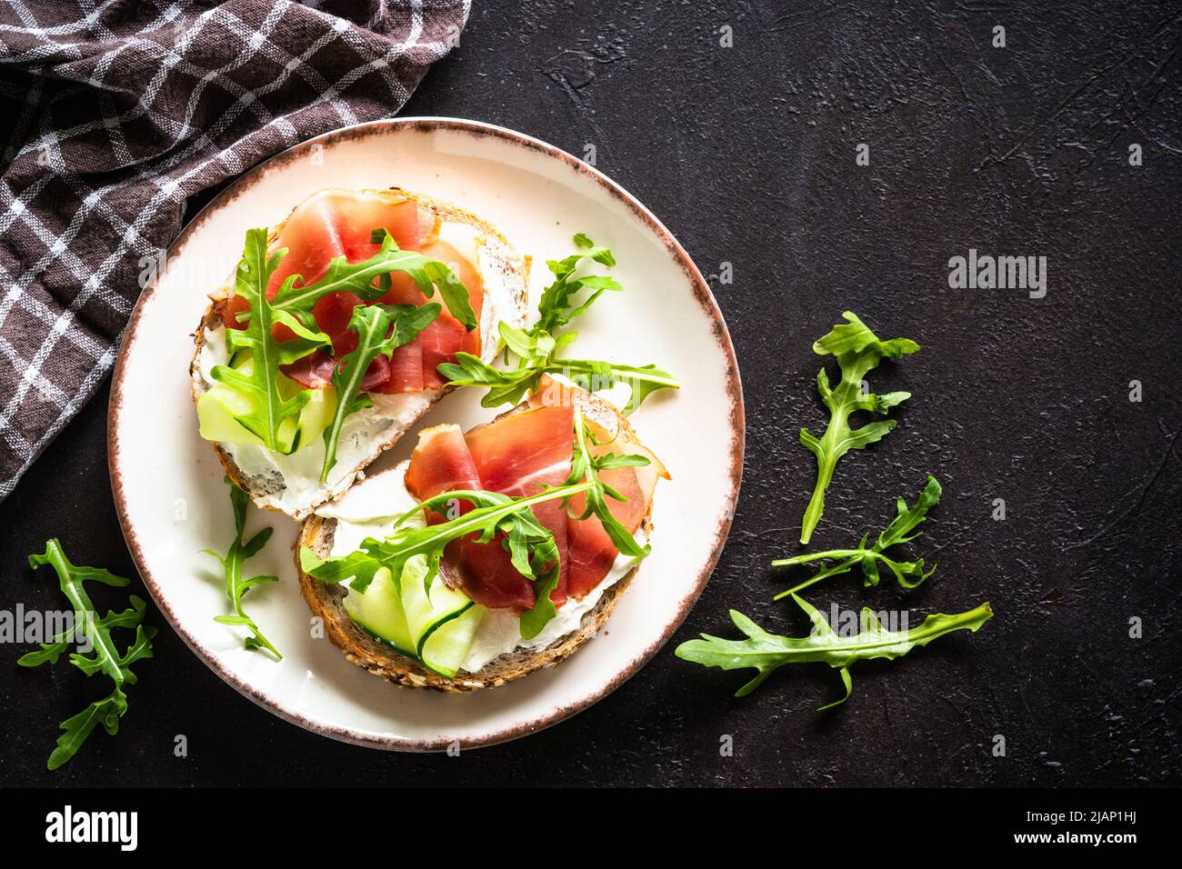 Open sandwich with cream cheese and prosciutto on dark Stock Photo Alamy