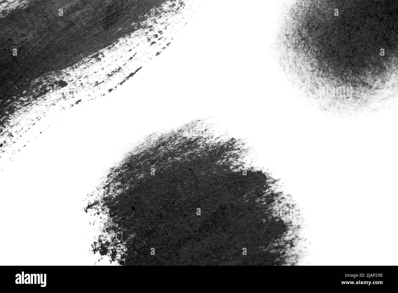 Black brush strokes oil paints on white paper. Isolated white ...