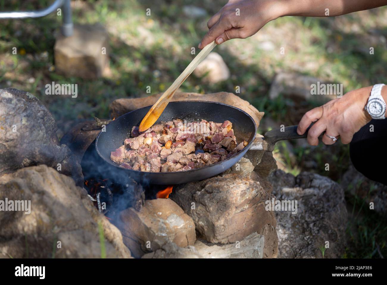 Cooking veal liver in pan at camp Stock Photo Alamy