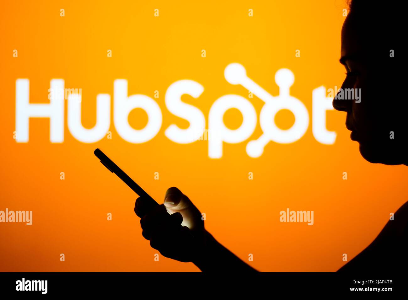Brazil. 30th May, 2022. In this photo illustration, the HubSpot logo is seen in the background of a silhouetted woman holding a mobile phone. (Credit Image: © Rafael Henrique/SOPA Images via ZUMA Press Wire) Stock Photo