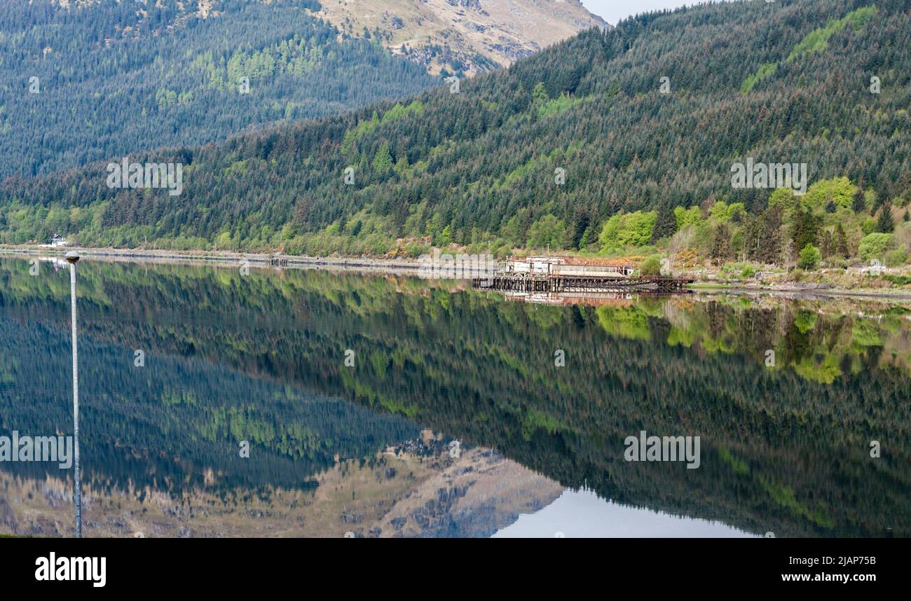 A scenic view of Loch Long at Arrochar,Scotland,UK with mirror like reflections of the mountains in the loch. Stock Photo