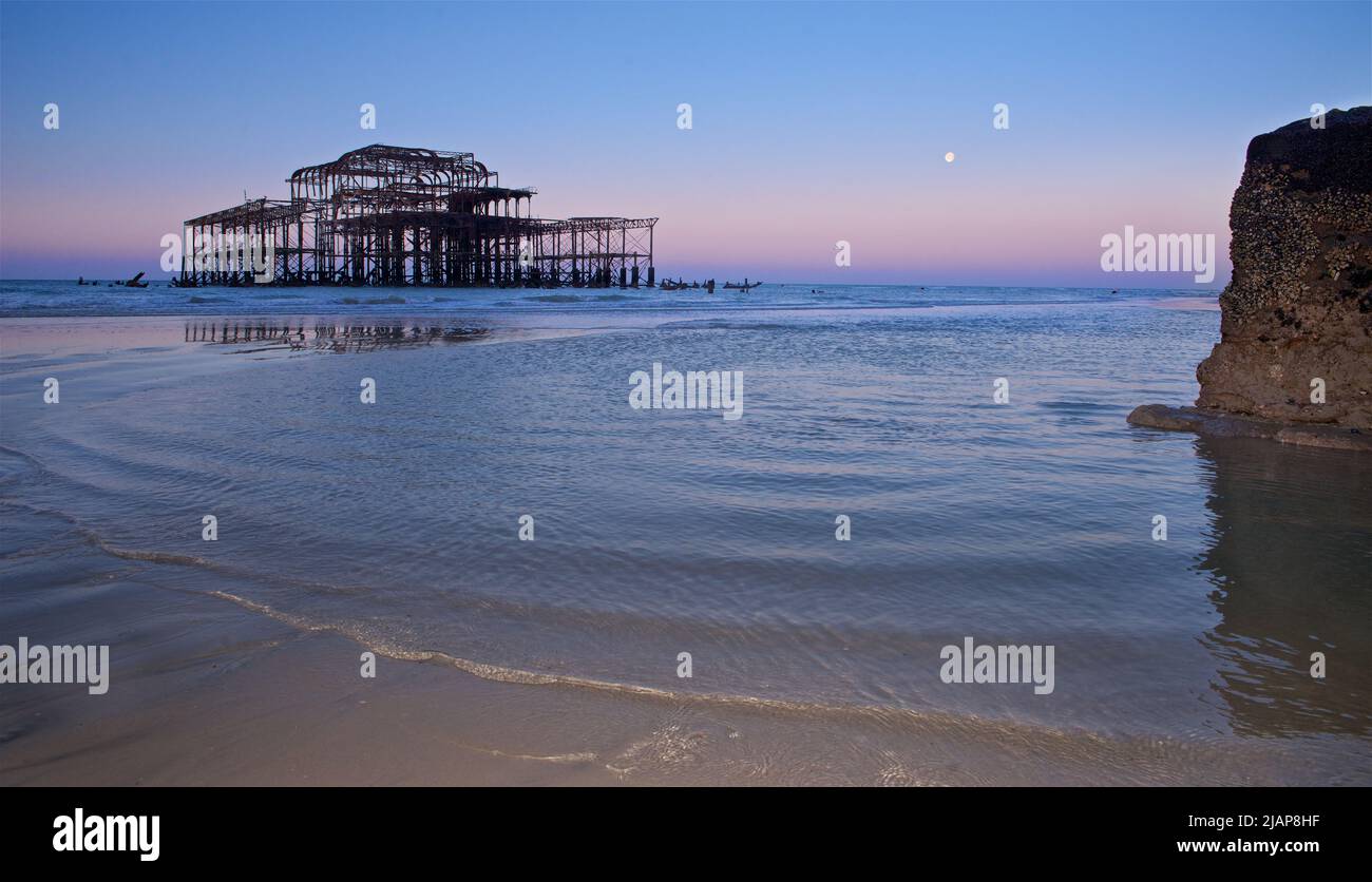 Rusting remains of the dilapidated West Pier at dawn low tide. Brighton & Hove, Sussex, England