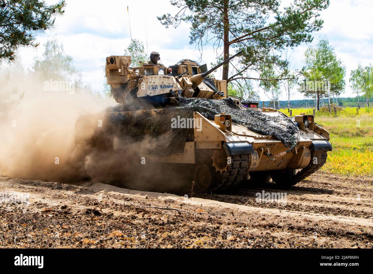Germany. 24th May, 2022. An M2A3 Bradley fighting vehicle assigned to 1st Battalion, 8th Infantry Regiment, 3rd Armored Brigade Combat Team, 4th Infantry Division, advances during a live-fire exercise as part of DEFENDER-Europe 22 at Oberlausitz Training Area, Germany, May 24, 2022. DEFENDER-Europe 22 is a series of U.S. Army Europe and Africa multinational training exercises within U.S. European Commands Large Global Scale Exercise construct taking place in Eastern Europe. DEFENDER-Europe 22 demonstrates U.S. Army Europe and Africa's ability to conduct large scale ground combat operations ac Stock Photo