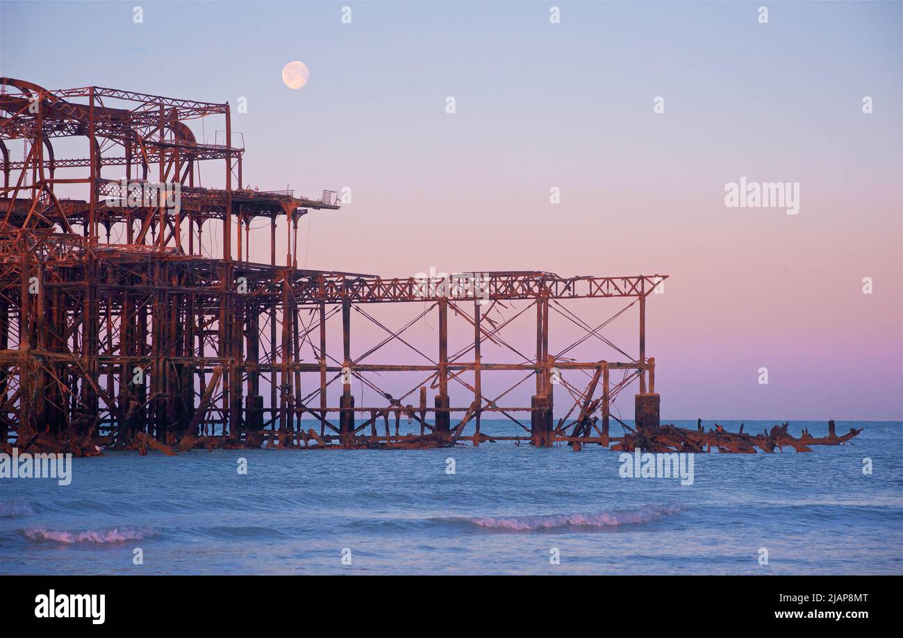 Rusting remains of the dilapidated West Pier at dawn low tide. Brighton & Hove, Sussex, England