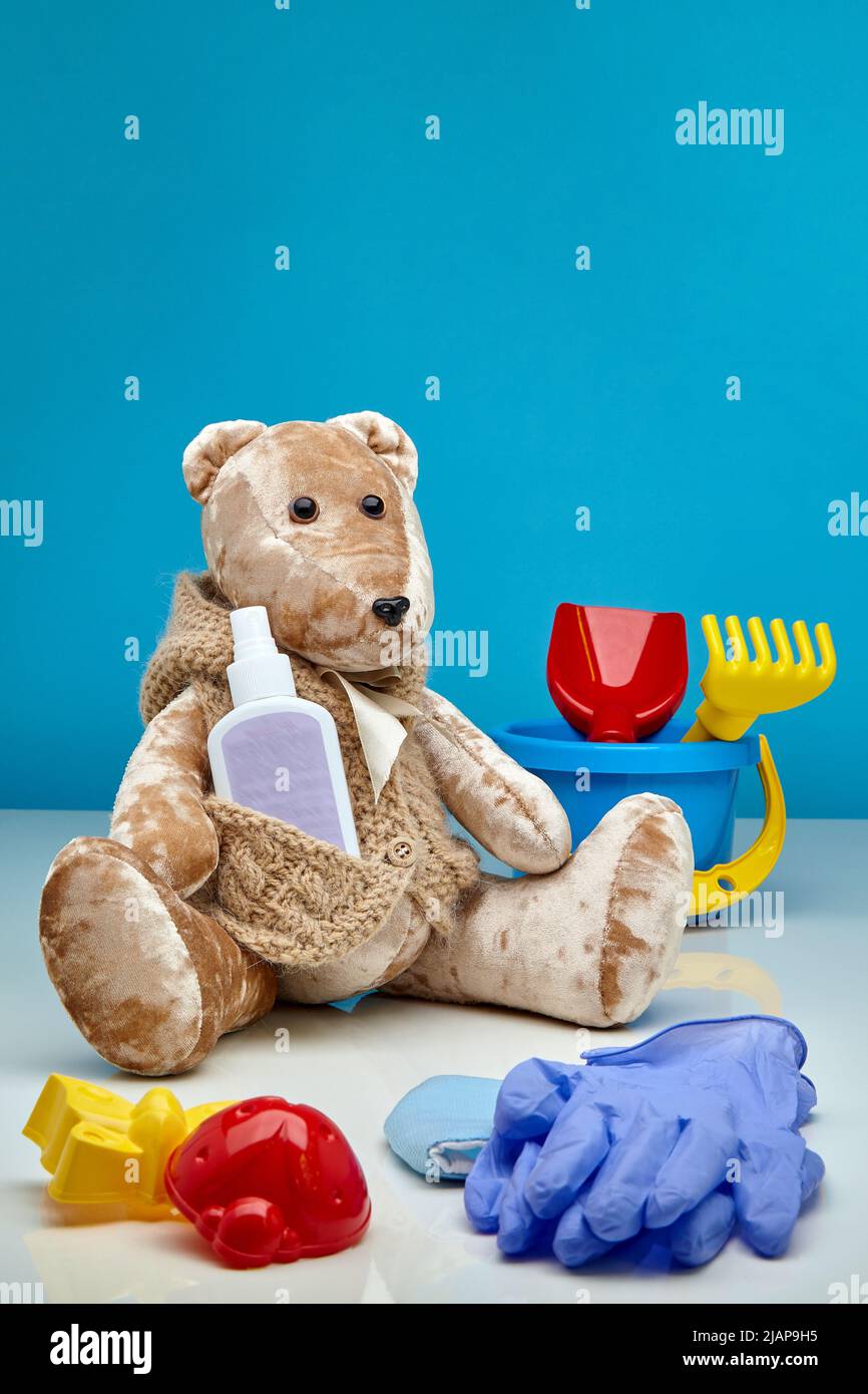 Teddy bear with medical gloves and antiseptic. Protecting children from