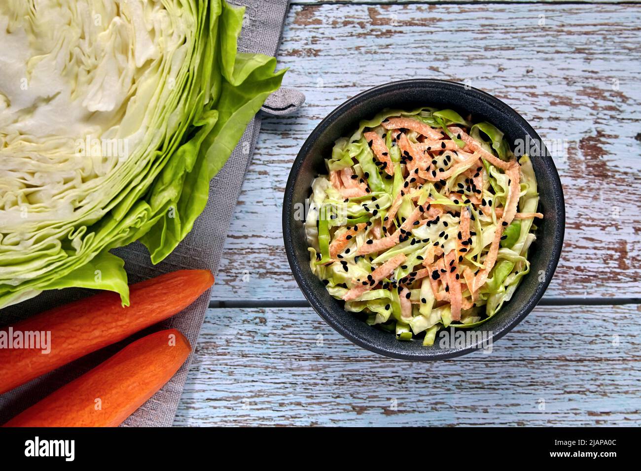 Healthy vegetarian food. Coleslow. White cabbage and carrot salad with black cumin seeds and