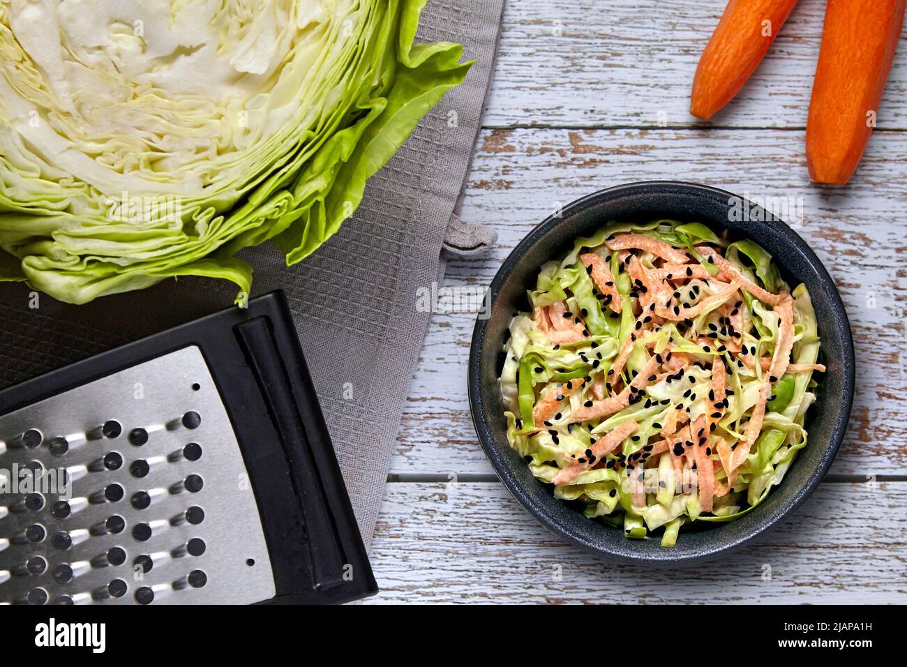 Healthy vegetarian food. Coleslow. White cabbage and carrot salad with black cumin seeds and