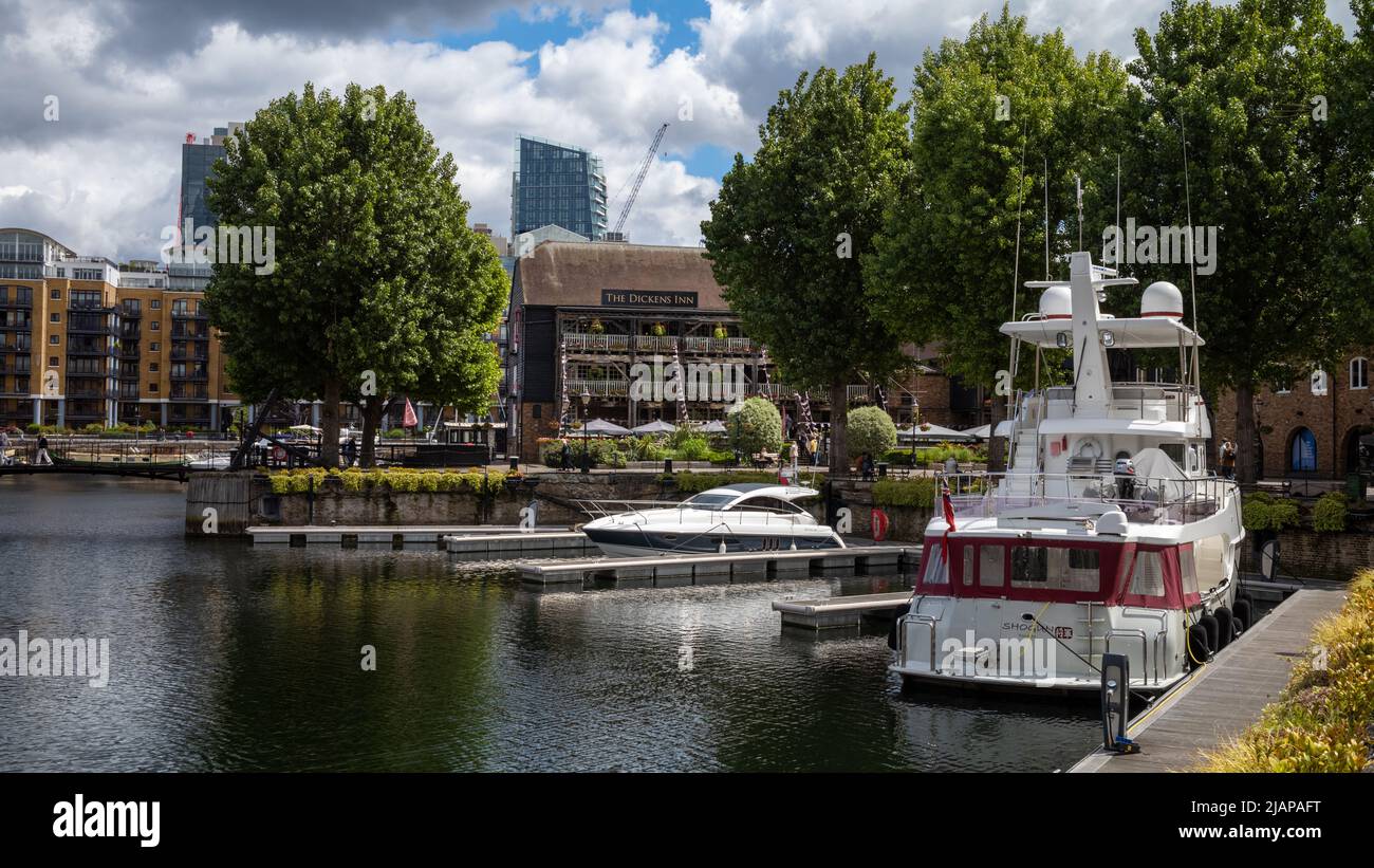 The Dickens Inn, housed within a renovated warehouse,  seen across the water at St Katharine Dock in London Stock Photo