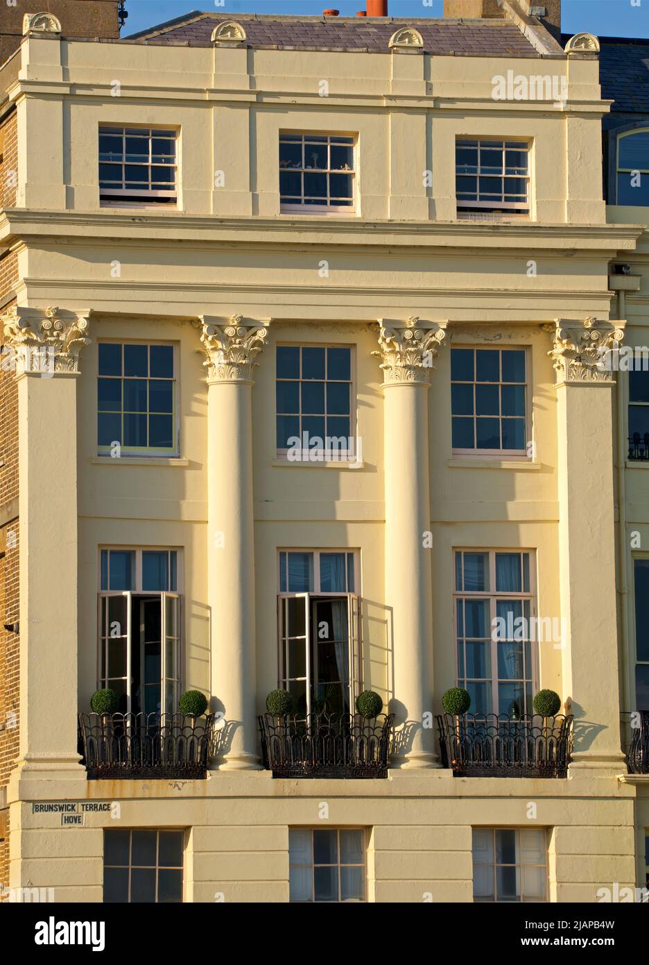 The facade of a Regency townhouse on Brunswick Terrace, part of a complex of Georgian townhouses in Hove on Brighton and Hove seafront.  East Sussex, England UK Stock Photo