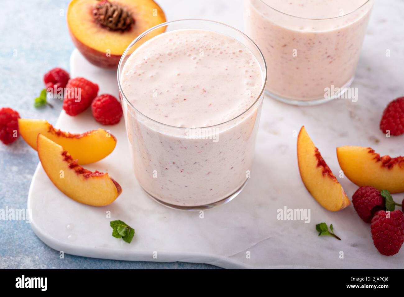 Raspberry peach smoothie, healthy and refreshing drink Stock Photo Alamy