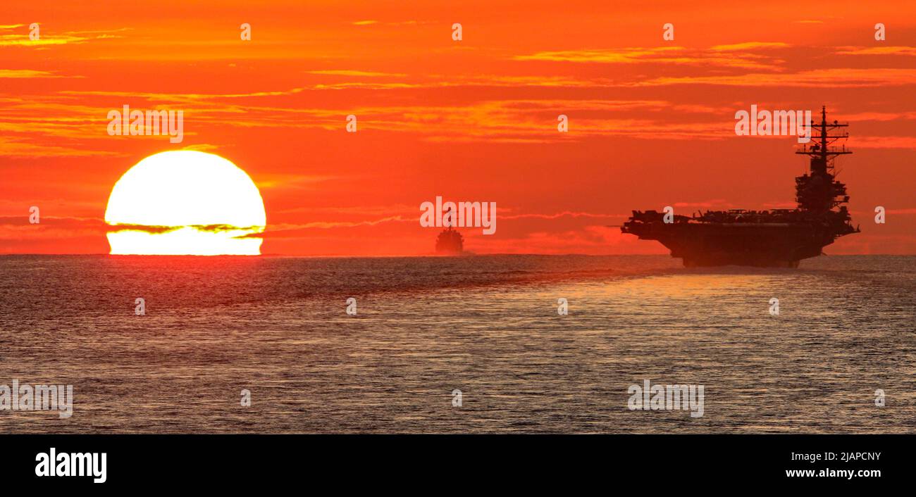 The US NavyÕs only forward-deployed aircraft carrier USS Ronald Reagan (CVN 76) transits the South China Sea with the Arleigh Burke-class guided missile destroyer USS Halsey (DDG 97) and the Ticonderoga-class guided-missile cruiser USS Shiloh (CG 67). Reagan is part of Task Force 70/Carrier Strike Group 5, conducting underway operations in support of a free and open Indo-Pacific. STRAITS OF MALACCA, 18 June 2021.  Optimised version of a U.S. Navy photo. Credit US Navy/R.Madanat) Stock Photo