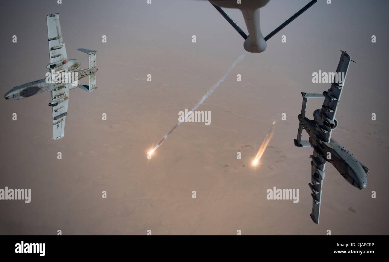 U.S. Air Force A-10 Thunderbolt IIs fire flares while breaking away after aerial re-fueling from a KC-135 Stratotanker assigned to the 340th Expeditionary Aerial Refueling Squadron out of Kandahar Airfield, Afghanistan, Aug. 15, 2019. The A-10 provides coalition forces with close air support and precision strike capacity for targeting Taliban revenue sources. Optimised version of a USAF photo. Credit US Navy / K. Bowes Stock Photo