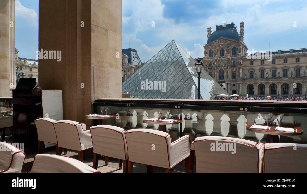 Le Cafe Marly, 93 Rue de Rivoli, overlooking the glass pyramid and courtyard of the Louvre. Stock Photo