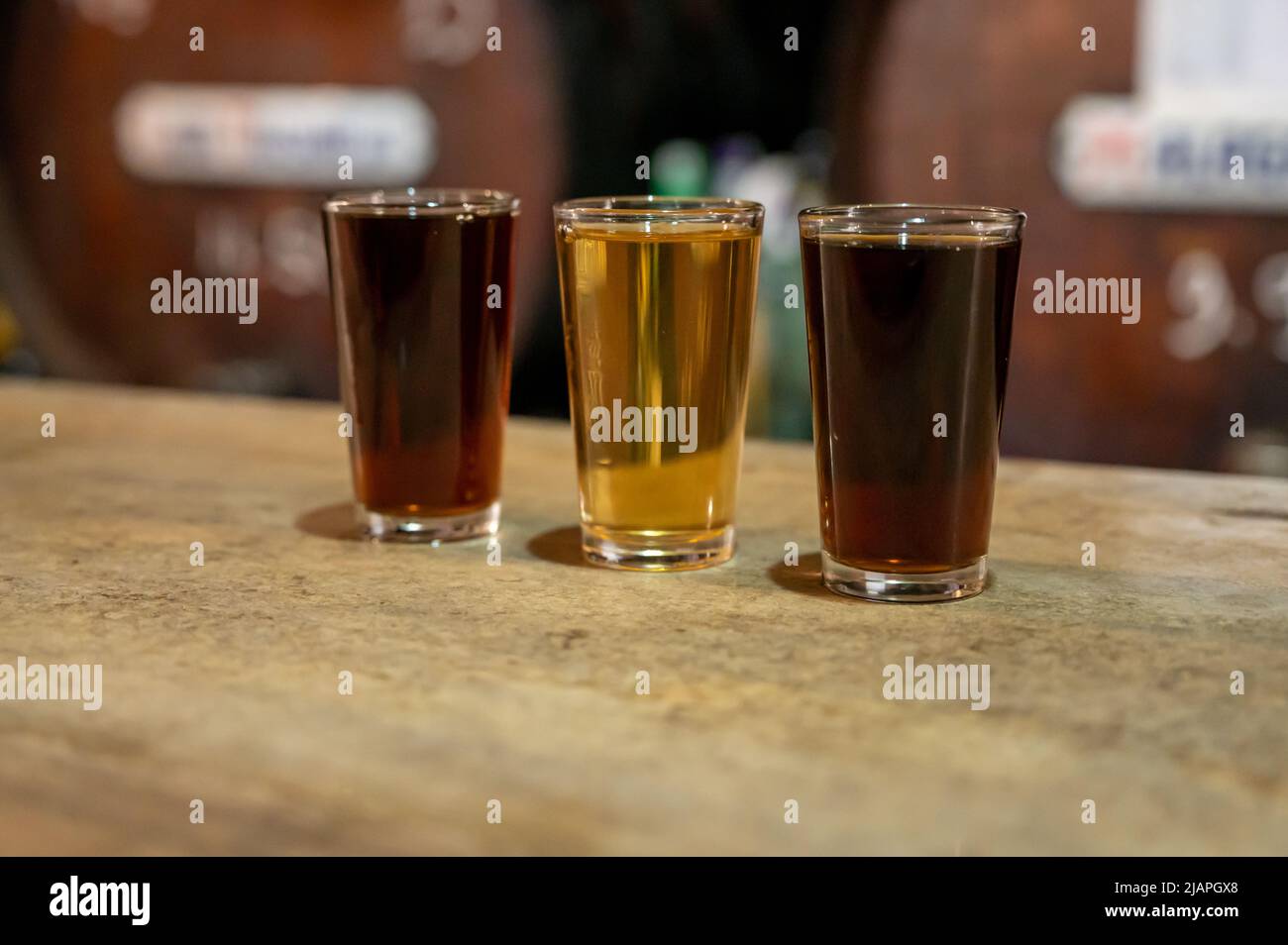 Tasting of different sweet wines from wooden barrels on old bodega wine