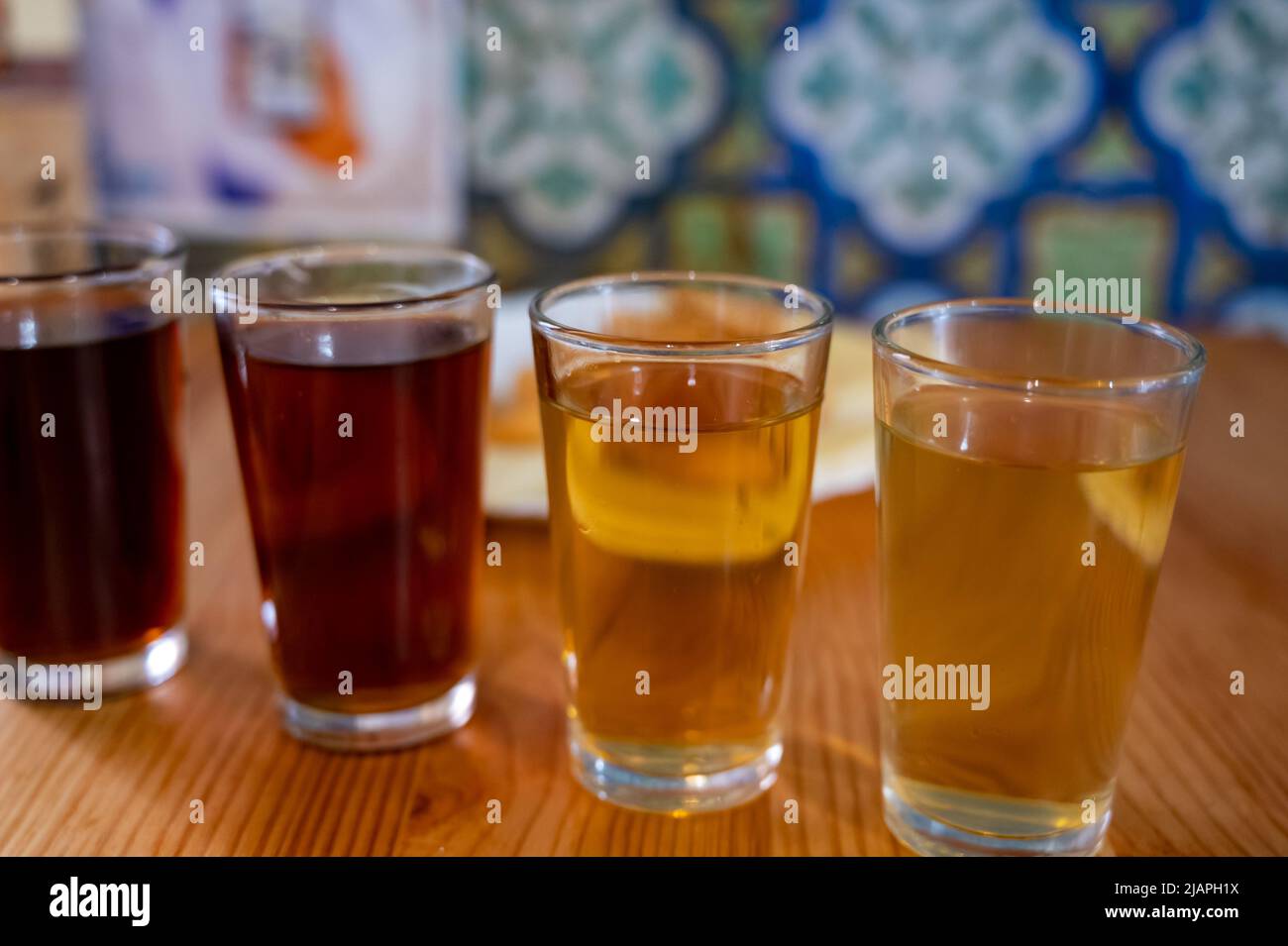 Tasting of different sweet wines from wooden barrels on old bodega wine