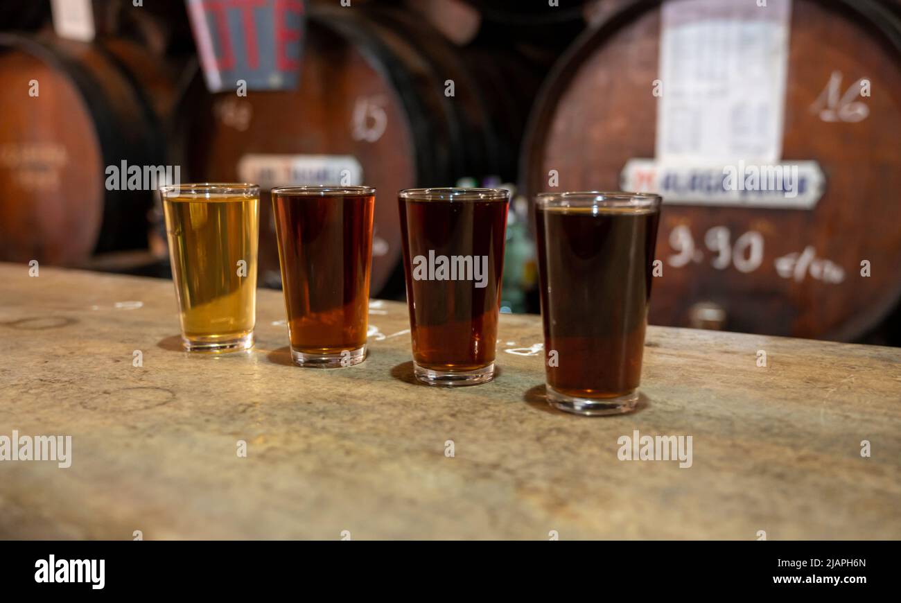 Tasting of different sweet wines from wooden barrels on old bodega wine