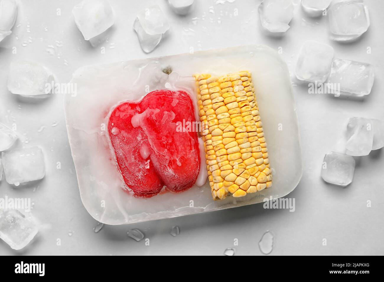 Fresh vegetables frozen in ice on light background Stock Photo Alamy