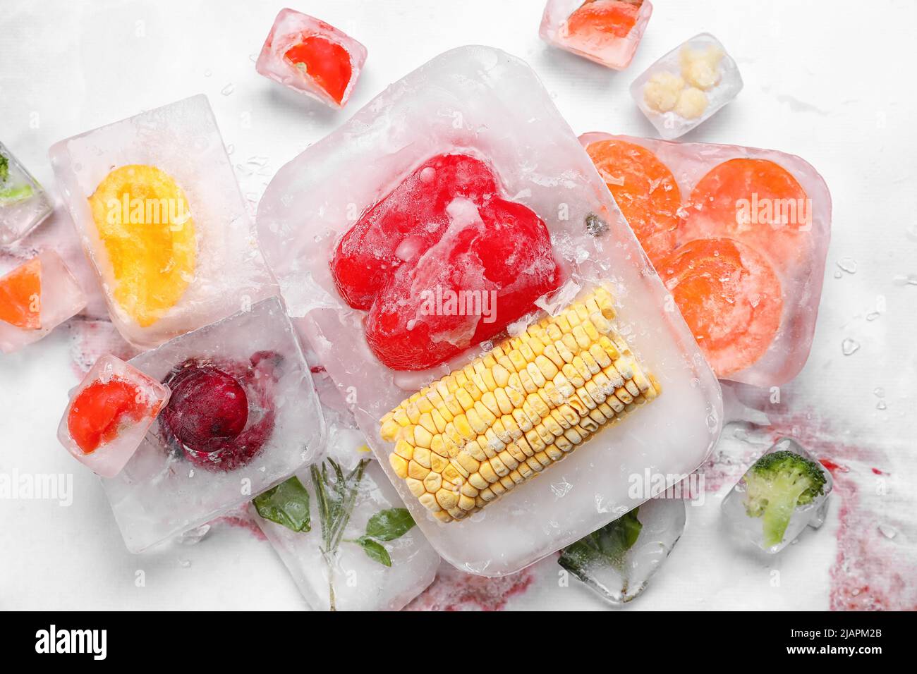 Fresh vegetables frozen in ice on light background Stock Photo Alamy