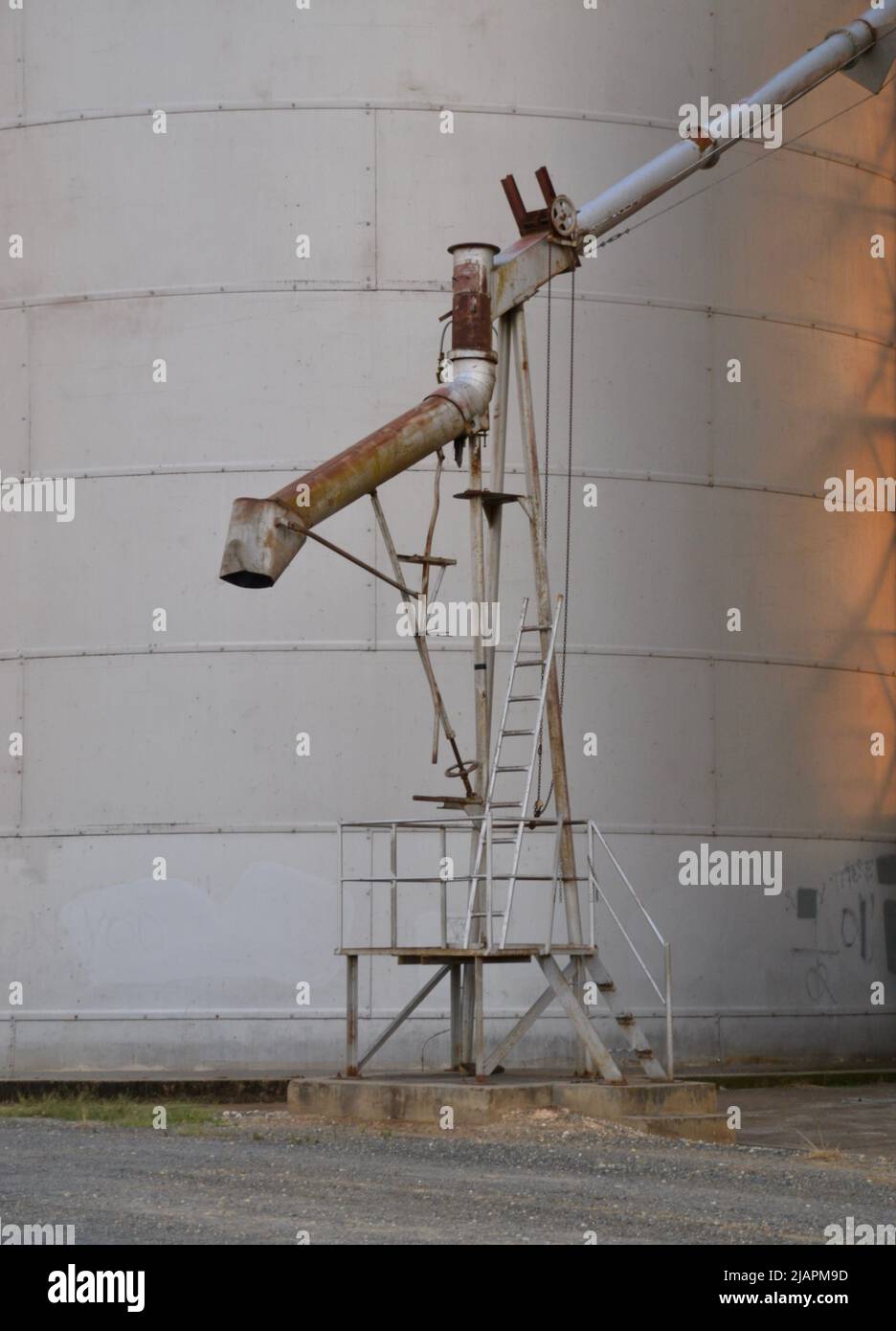 A steel, metal or aluminium tube shute and loading hopper on the side of a grain silo in regional Australian farming community of Rutherglen, Victoria Stock Photo