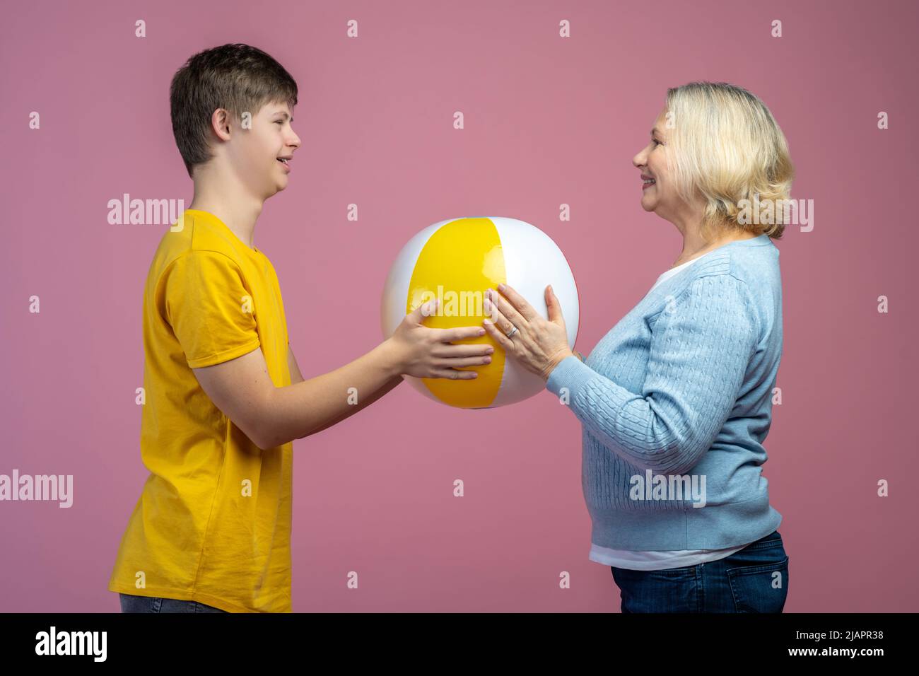 Woman and guy touching ball standing opposite each other Stock Photo