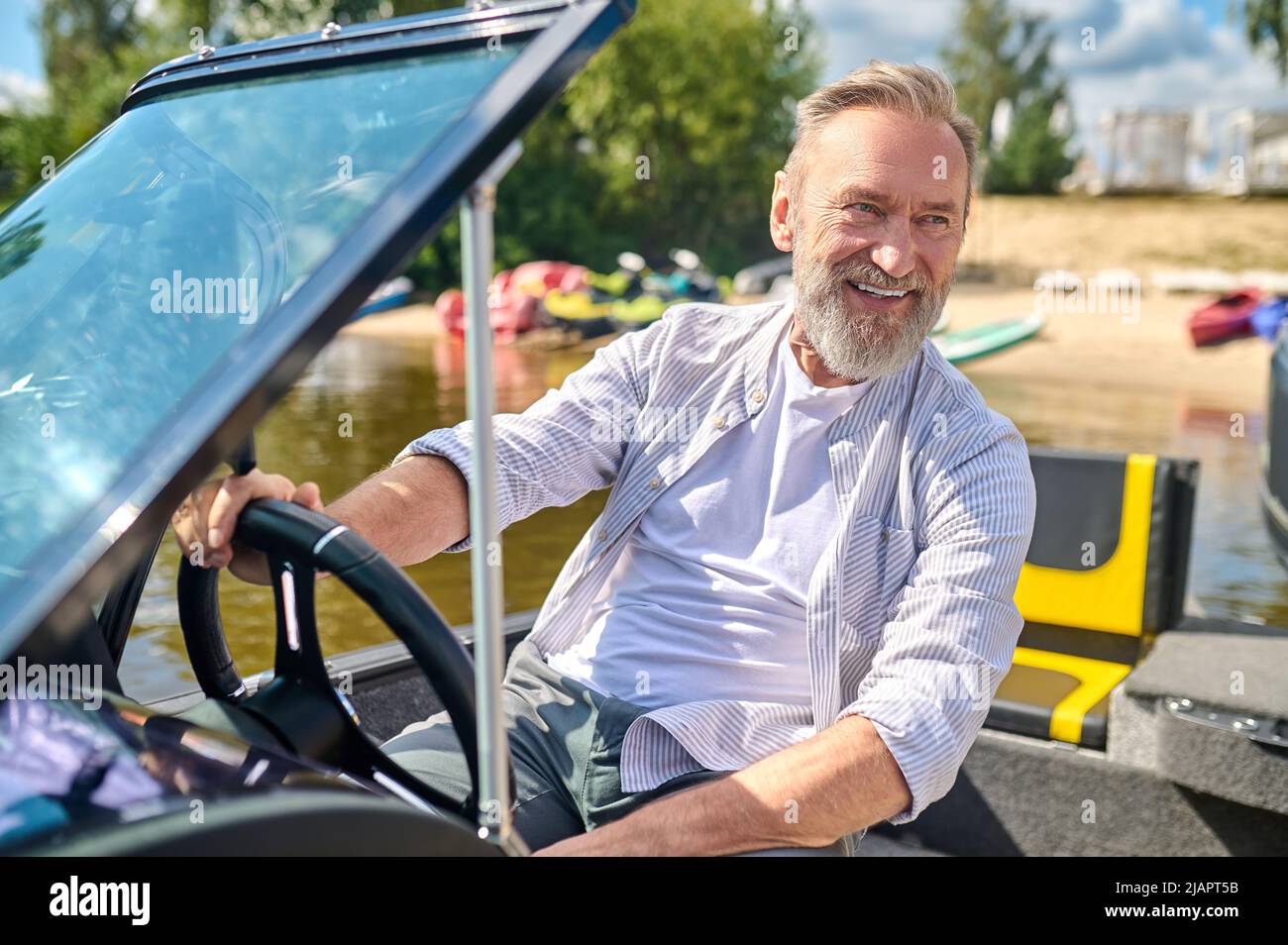 Happy man wheel yacht hi-res stock photography and images - Alamy